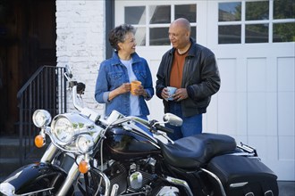 Senior African American couple next to motorcycle