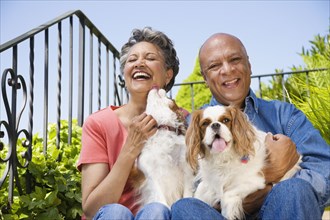 Senior African American couple with dogs
