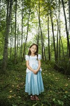 Asian girl wearing costume in woods