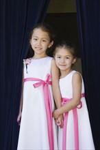 Young Asian flower girls holding hands