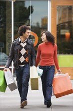 Couple carrying shopping bags