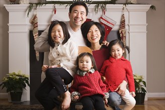 Asian family posing for Christmas photograph