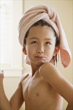 Mixed race girl with towel on head