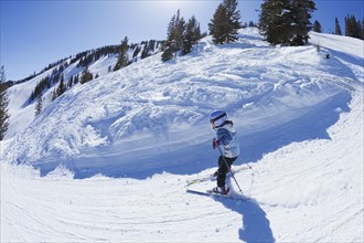 Mixed race girl skiing downhill