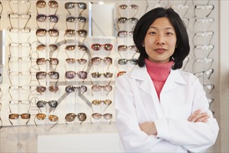 Korean optician standing in store