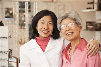 Korean optician standing with customer