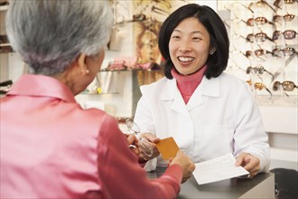 Korean optician talking to customer