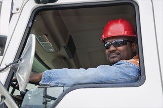 African construction worker driving truck