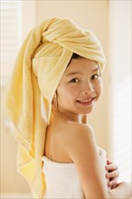 Mixed race girl wrapped in a towel