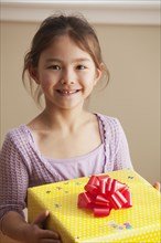 Mixed race girl holding birthday gift