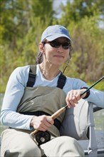Japanese American woman holding fly fishing pole