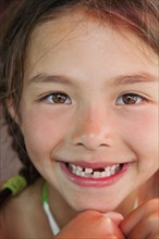 Mixed race girl with tooth missing