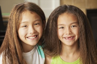Mixed race sisters smiling