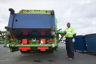 Black man operating garbage truck