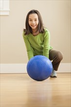 Smiling girl playing with ball