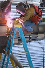 Construction worker welding metal