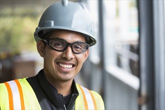 Hispanic man smiling at construction site