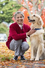 Mixed race woman petting dog
