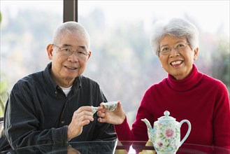 Chinese couple having tea together
