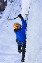 Caucasian climber scaling glacier