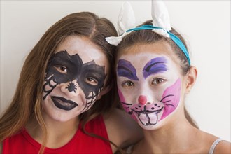 Mixed race girls wearing face paint