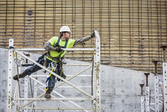Caucasian worker on scaffolding