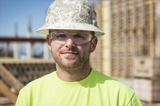 Worker smiling on construction site