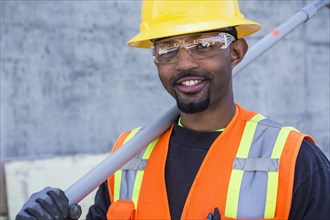Black worker smiling on construction site