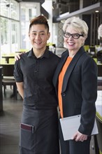 Businesswoman and water smiling in restaurant