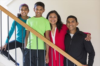 Close up of Indian family smiling on staircase