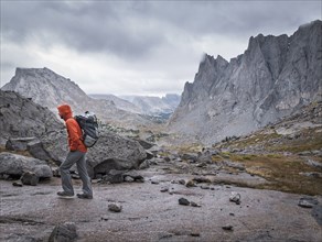 Caucasian hiker walking near mountains