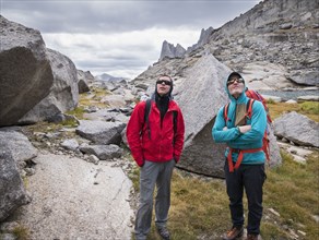 Caucasian climbers admiring mountainside
