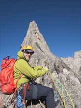 Caucasian climber smiling on mountainside