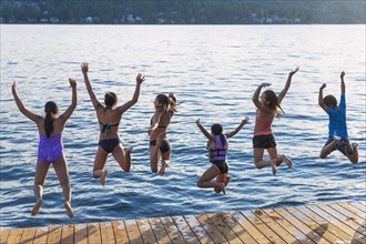 Children jumping into lake
