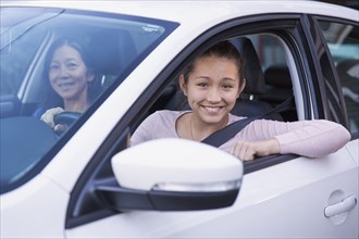 Mother teaching daughter to drive car