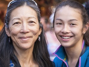 Close up of smiling Asian mother and daughter