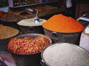 Buckets of dried spices for sale in market