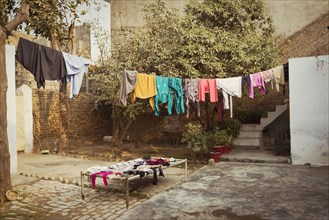 Laundry drying on clothesline in backyard