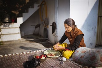 Woman preparing food outdoors