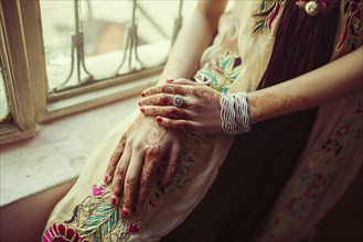 Mixed race girl with henna tattoos on hands