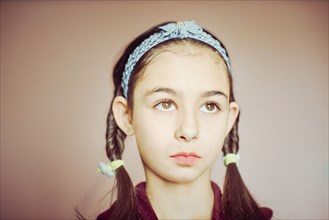 Mixed race girl wearing braid pigtails