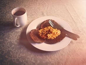 Scrambled egg and toast breakfast with coffee