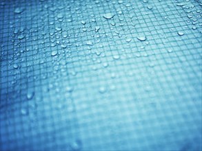 Close up of water droplets on grid surface