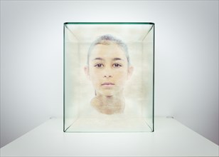 Hologram of Mixed race girl in glass box