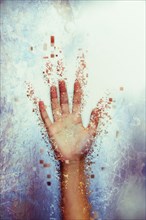 Pixelated hand dissolving