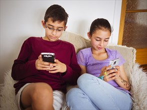Mixed race children using cell phones