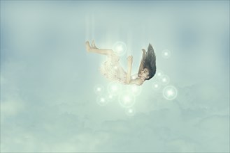 Mixed race girl falling in sky