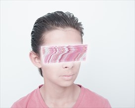 Mixed race boy with glitch covering eyes