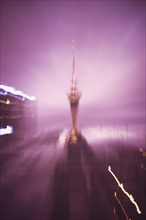 Blurred view of Sky Tower in Auckland cityscape