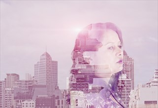 Double exposure of mixed race woman and cityscape